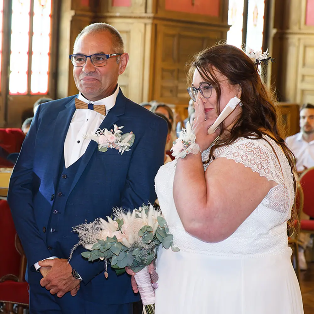 Moment d'émotion à la mairie d'Hénin-Beaumont | Photographe mariage Photo de mariage de Virginie et Yannick. La mariée essuie une larme de joie à la mairie d'Hénin-Beaumont pendant que son époux la regarde tendrement. Un reportage photo rempli d'émotions et de spontanéité.