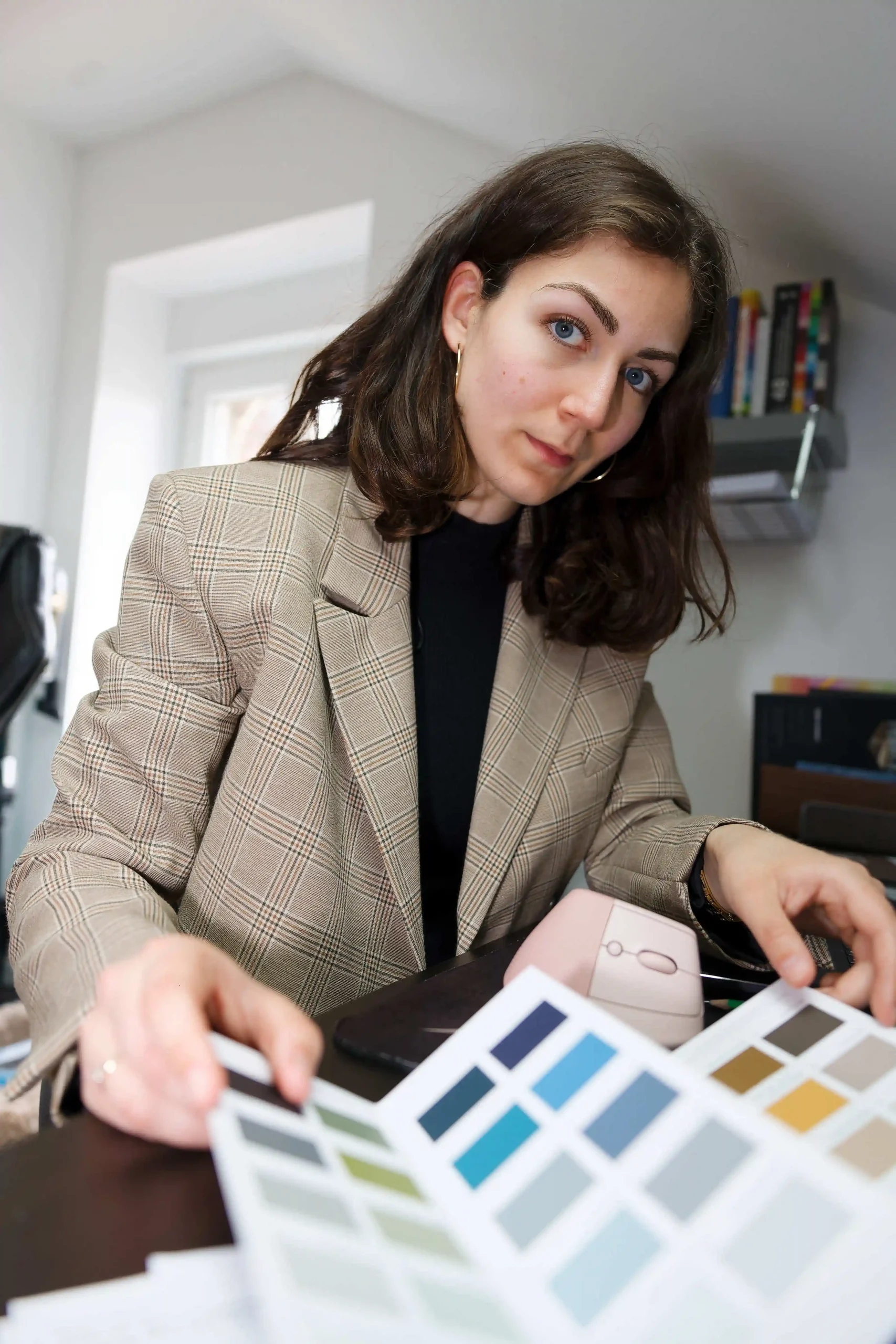 Une architecte d'intérieur examine des échantillons de couleur pour un projet de décoration ou d'aménagement.